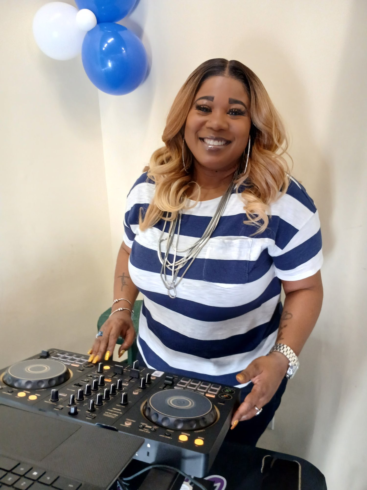 Jacquell The Apostle smiling at her DJ controller